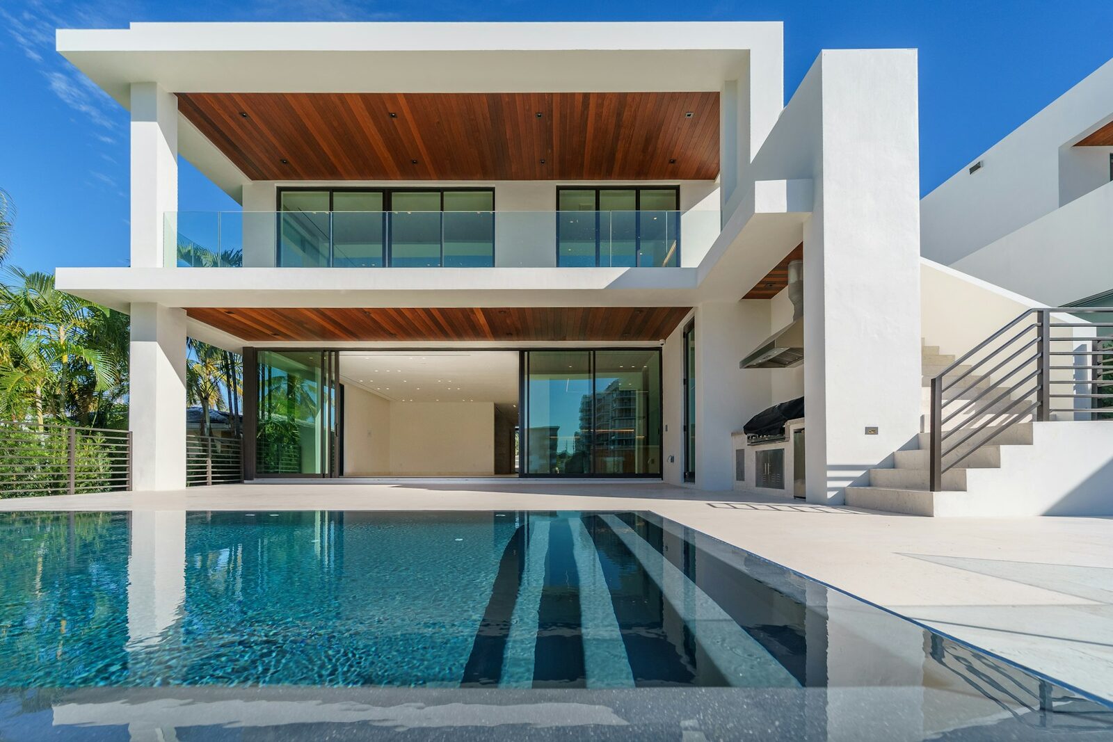 Modern luxury Phoenix home exterior with pool and palm trees